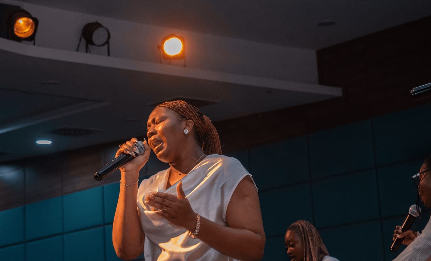 A student leading worship with a microphone